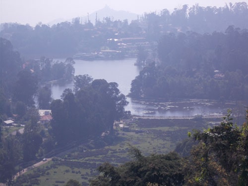 Kodaikanal Lake boating view with surrounding pine hills, Kodaikanal Lake in August surrounded by mist and pine trees